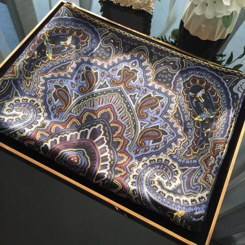 Collection of 100% mulberry silk bandanas with paisley prints and hand-rolled edges.